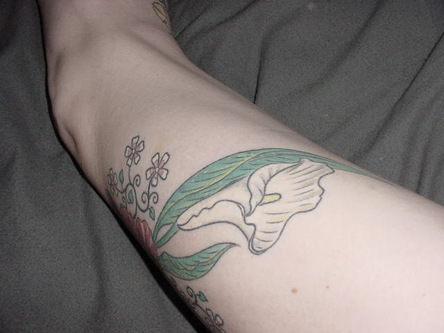 calla lilly tattoos. a Calla lily on the side.