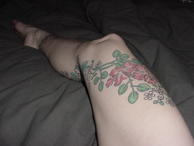  a winding vine of flowers on my right leg: